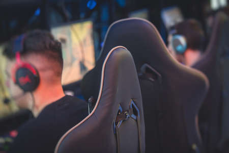 Cyber sport e-sports tournament, team of professional gamers, close-up on gamer's hands on a keyboard, pushing button, gamers playing in competitive moba, strategy fps game at cyber games arena clubの写真素材