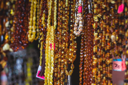 Variety assortment of souvenirs made of amber, traditional tourist souvenirs and gifts from Kaliningrad, Russia, in local souvenir shopの写真素材