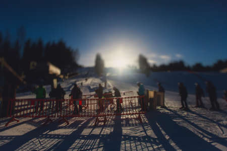 Beautiful cold mountain view of ski resort, sunny winter day with slope, piste and ski lift, with a...
