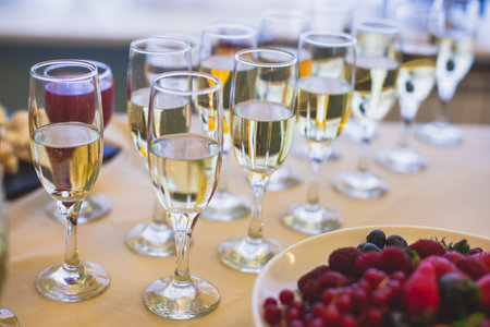 Beautifully decorated catering banquet table with different food snacks and appetizers on corporate christmas birthday party event or wedding celebration, with alcohol beveragesの写真素材