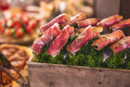 Beautifully decorated catering banquet table with different food snacks and appetizers on corporate christmas birthday party event or wedding reception celebrationの写真素材