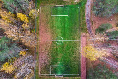 Aerial drone view of football soccer pitch field, green grass fall autumn vibrant pitch playground...