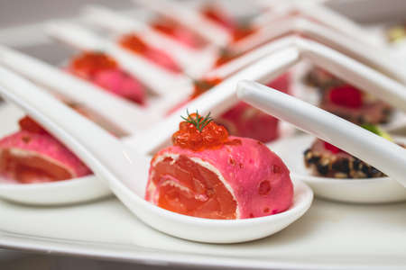 Catering table, beautifully decorated banquet with variety of with different food snacks and...