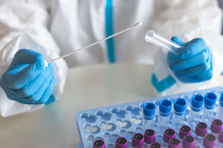 Process of coronavirus PCR antigen testing examination by nurse medic in laboratory lab, COVID-19...