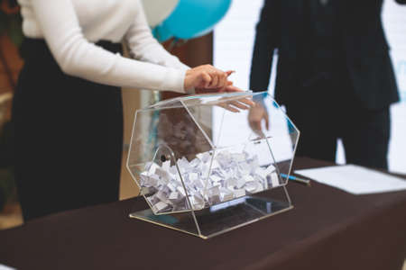 Professional climber rope access worker with a shovel removes snow and take off icicle from high rise building, industrial mountaineers working at heights, manual snow removal, cleaning roofsの写真素材