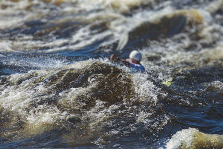 Kayak slalom canoe race in white water rapid river, process of kayaking competition with the colorful canoe kayak boat paddling, process of canoeing with big water splashの写真素材