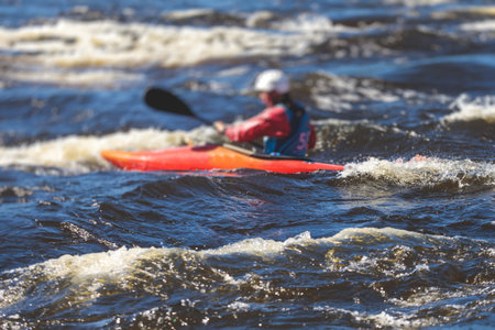 Kayak slalom canoe race in white water rapid river, process of kayaking competition with the colorful canoe kayak boat paddling, process of canoeing with big water splashの写真素材