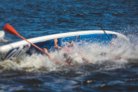Group of young SUP surfers fall from stand up paddle board, women drowning, concept of fail solving...
