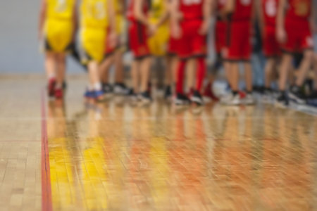 View of basketball court hall indoor venue with junior teenage school team playing in the background, basketball match game on the arena stadium, team is blurred with copy spaceの写真素材