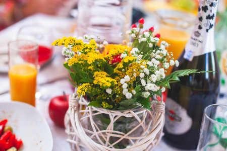 Beautiful table decoration in orange autumn fall colours, table arrangement on event in a restaurant with flowers, bouquet, berries, fruits and leaves on wedding reception banquet partyの写真素材