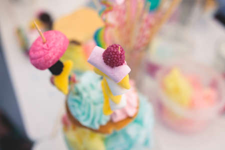Over shake and freak shake, process of cooking extreme colorful milkshakes on a kids birthday party event celebration, catering banquet table with candy sweets desserts, monster shakesの写真素材