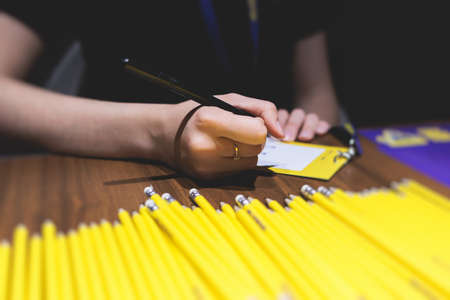 Process of checking in on a conference congress forum event, the registration desk table, visitors...