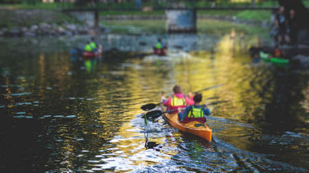 A process of kayaking in the city river canals, with colorful canoe kayak boat paddling, process of canoeing, group of kayaks, colorful canoe kayak boat paddling, summer dayの写真素材