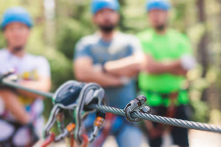 View of high ropes course, process of climbing in amusement acitivity rope park, passing obstacles...