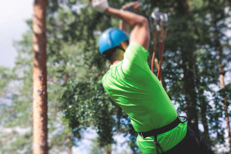 View of high ropes course, process of climbing in amusement acitivity rope park, passing obstacles...