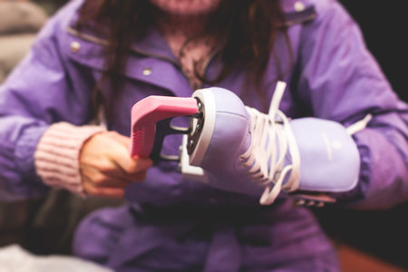 Close up view of a new purple violet pink ice skates boots on rink in motion, girl ice skating on arena, concept of ice skating in winter, holiday christmas timeの写真素材