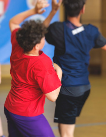 Junior teenage school team of kids children play basketball, players in the hall indoor venue court,...