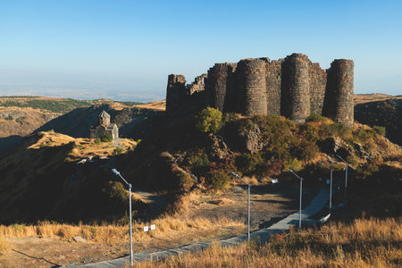 Beautiful sunny view of Amberd fortress, Mount Aragats with horse pasturing, Aragatsotn, Armenia in summer dayの写真素材