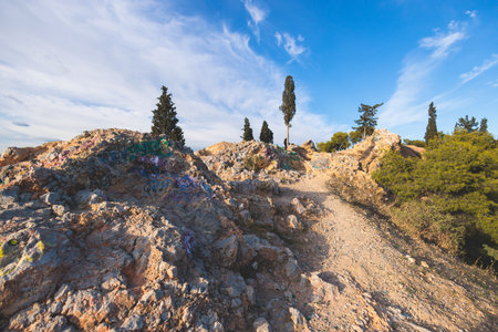 Athens, Attica, beautiful super-wide summer angle view of Athens, Greece, with Acropolis, Mount Lycabettus, mountains and scenery beyond the city, seen from Strefi Hill in Exarcheia neighbourhoodの写真素材