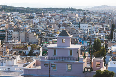 Athens, Attica, beautiful super-wide summer angle view of Athens, Greece, with Acropolis, Mount Lycabettus, mountains and scenery beyond the city, seen from Strefi Hill in Exarcheia neighbourhoodの写真素材