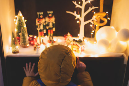 Kid child boy standing in front of store shopwindow with New year Christmas decorations of store front, showcase, glass case, shopfront decorated, Kid and Christmas shop market conceptの写真素材