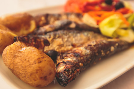 Close-up of portugese traditional grilled sardines sardinas on a plate with potatoes and vegetables, in Lisbon, Potrugalの写真素材