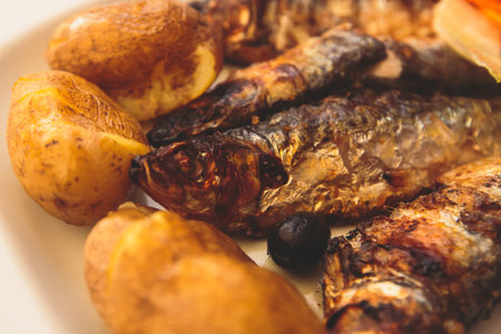 Close-up of portugese traditional grilled sardines sardinas on a plate with potatoes and vegetables, in Lisbon, Potrugalの写真素材
