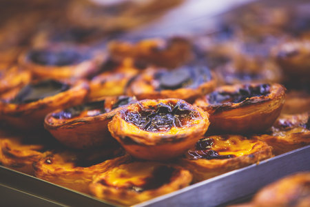 Traditional Portuguese egg tart pasty cakes, dessert Pasteis de nata with different portuguese...