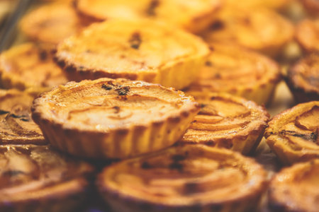 Traditional Portuguese egg tart pasty cakes, dessert Pasteis de nata with different portuguese pastry on the cafe store window, pastel de nataの写真素材