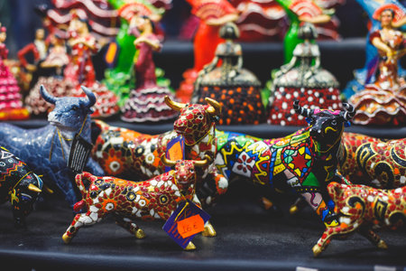 View of traditional tourist souvenirs and gifts from Spain, Alicante, Valencia with toys, bull figures, flamenco dancer dolls, fridge magnets with and key ring keychain, in local vendor souvenir shopの写真素材
