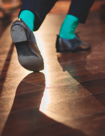 Dancing shoes of young couple dance retro jazz swing dances on a ballroom club wooden floor, close up view of a shoes, female and male, dance lessons class rehearsalの写真素材