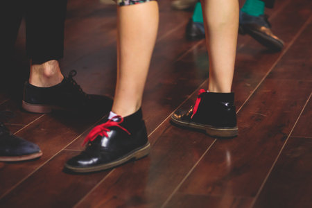 Dancing shoes of young couple dance retro jazz swing dances on a ballroom club wooden floor, close...
