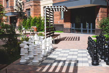 Modern european residential apartment complex yard territory, multi-story house buildings with playground and benches, contemporary scandinavian housing development, facade exterior and a courtyardの写真素材