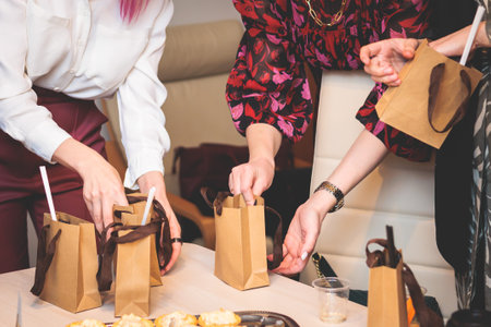 Corporate gifts and souvenirs for employees of the company, gift bag package for conference participants before start, process of presentation of corporate gifts, gift giving at the office workの写真素材