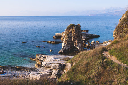 Aerial view of beach in Kassiopi village in northeast coast of Corfu island, Ionian Islands, Kerkyra, Greece in summer sunny dayの写真素材