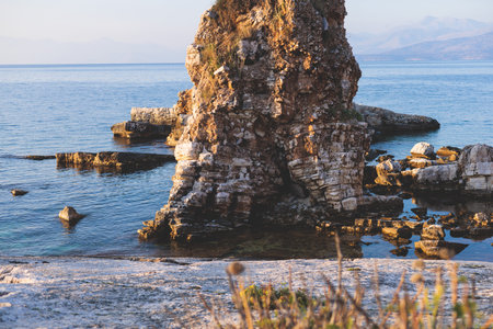 Aerial view of beach in Kassiopi village in northeast coast of Corfu island, Ionian Islands, Kerkyra, Greece in summer sunny dayの写真素材