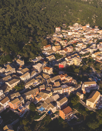 Beautiful aerial drone view of Lakones Village, traditional greek village near Paleokastritsa, Corfu island, Kerkyra, Ionian sea islands, Greece, in summer sunny day with a blue sky and mountainsの写真素材