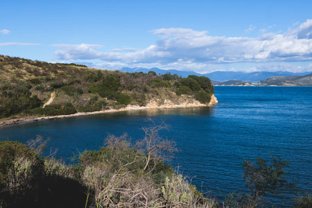 View of Erimitis coast landscape near Kassiopi and Agios Stefanos village, Corfu island, Kerkyra, Greece, with hiking trail path, forest and beach in summer sunny dayの写真素材