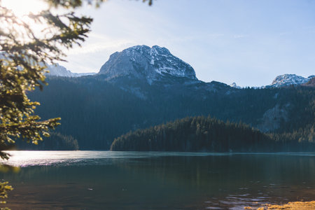 Beautiful view of Black lake, Crno Jezero in Durmitor National Park, Zabljak, northern Montenegro, landscape in a sunny day with blue sky, with glacial lake, forest hiking trail and mountainsの写真素材