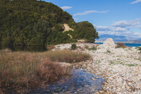 View of Erimitis coast landscape near Kassiopi and Agios Stefanos village, Corfu island, Kerkyra, Greece, with hiking trail path, forest and beach in summer sunny dayの写真素材