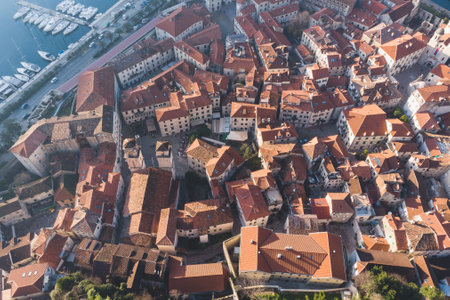 Kotor, Montenegro, beautiful top panoramic view of Kotor city old medieval town seen from San Giovanni St. John Fortress, with Adriatic sea, bay of Kotor and Dinaric Alps mountains in sunny dayの写真素材
