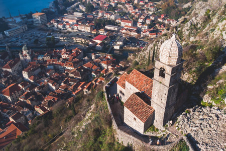 Kotor, Montenegro, beautiful top panoramic view of Kotor city old medieval town seen from San Giovanni St. John Fortress, with Adriatic sea, bay of Kotor and Dinaric Alps mountains in sunny dayの写真素材