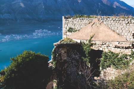Kotor, Montenegro, process of climbing to the top of San Giovanni Fortress, Fort St. John, old medieval town, hiking on the Ladder of Kotor, sunny day with blue sky and mount Lovcen and Orjenの写真素材