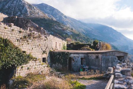 Kotor, Montenegro, process of climbing to the top of San Giovanni Fortress, Fort St. John, old medieval town, hiking on the Ladder of Kotor, sunny day with blue sky and mount Lovcen and Orjenの写真素材
