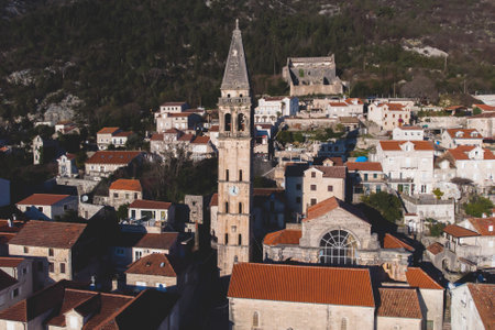 Perast, Montenegro, beautiful aerial top panoramic view of Perast old town with st. Nikola church, with Adriatic sea, bay of Kotor, Dinaric Alps mountains in a sunny dayの写真素材