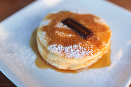 Sweet pancakes with syrup and jam on a plate, traditional breakfast dessertの写真素材