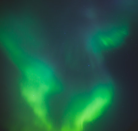 Beautiful picture of massive multicolored green vibrant Aurora Borealis, Aurora Polaris, also know as Northern Lights in the night sky over Norway, Scandinaviaの写真素材
