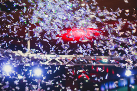 Colorful confetti explosion fired on dance floor air during a concert festival, crowded concert hall with scene stage lights, rock show performance, with people silhouetteの写真素材