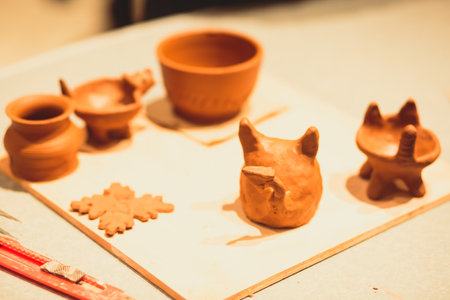 A process of pottery, with two people involved, working on pottery wheel and making clay pot