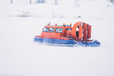 View of rescue team Hovercraft. hover craft transport boat crossing frozen river lake on the ice in the winter snowy dayの写真素材
